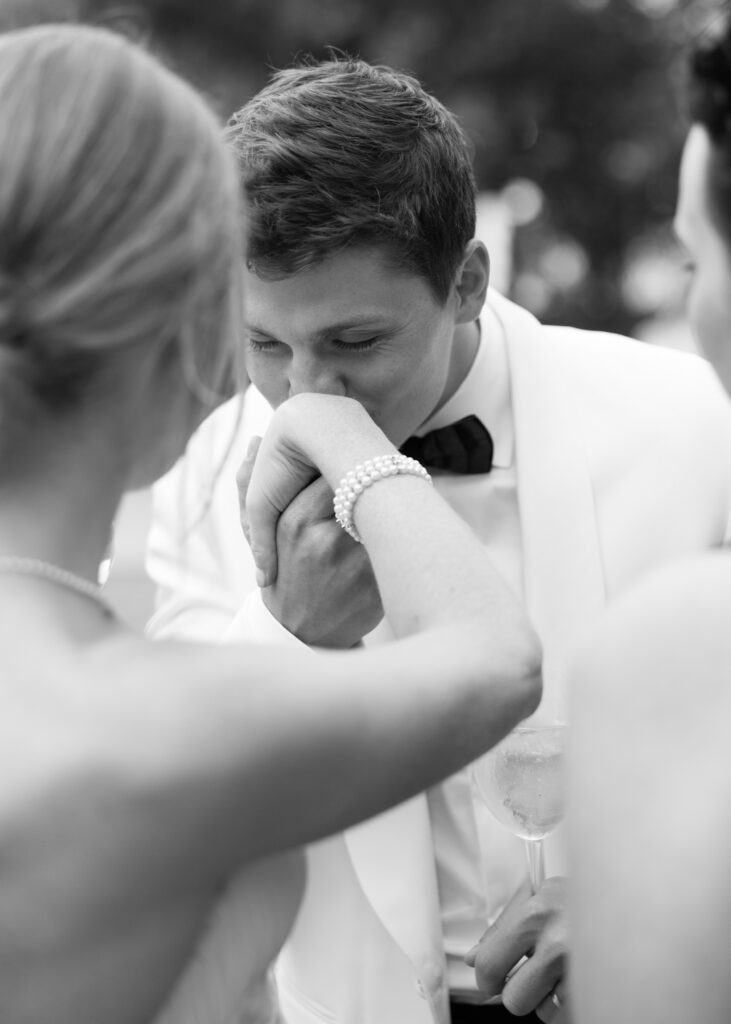 groom kissing brides hand