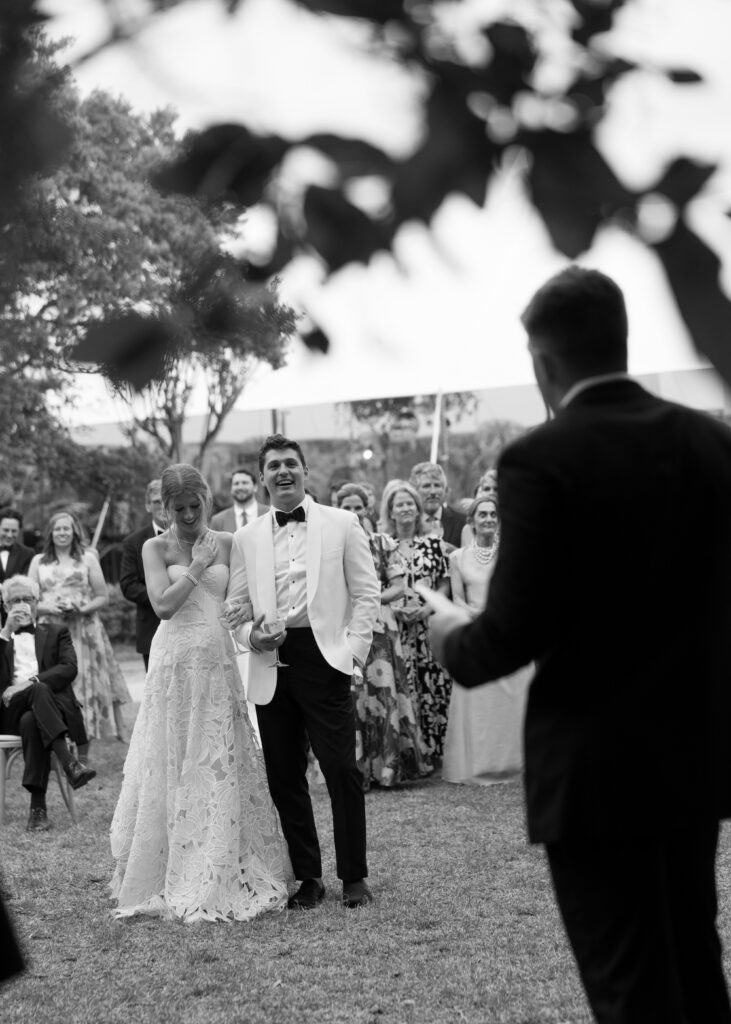 bride and groom laughing during reception speech